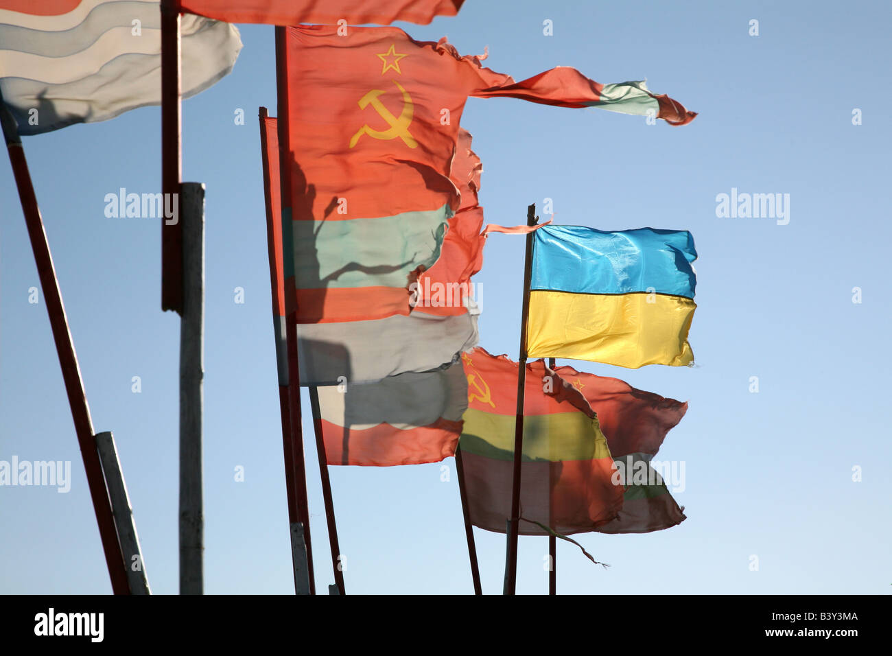 Old Soviet republics flags beside a modern Ukrainian flag waving over the pilgrim camp on the Solovetsky Islands, Russia Stock Photo