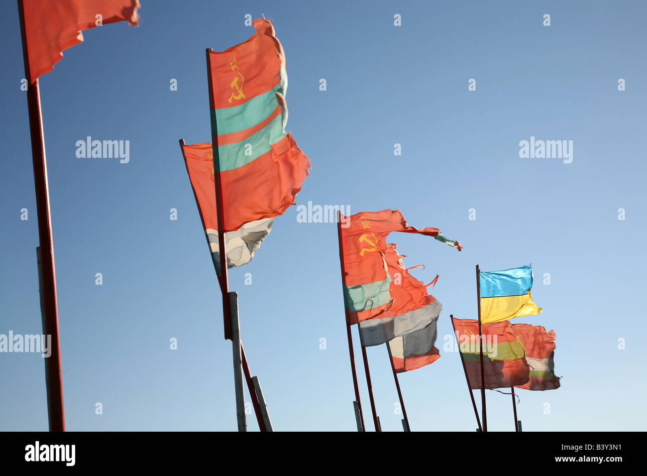 Old Soviet republics flags beside a modern Ukrainian flag waving over the pilgrim camp on the Solovetsky Islands, Russia Stock Photo