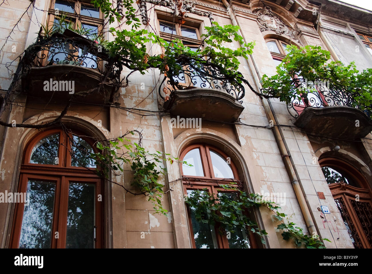 Bucharest Romania Baroque style residence on Bulevardul Magheru showing swirling ironwork and vines balcony detail Stock Photo