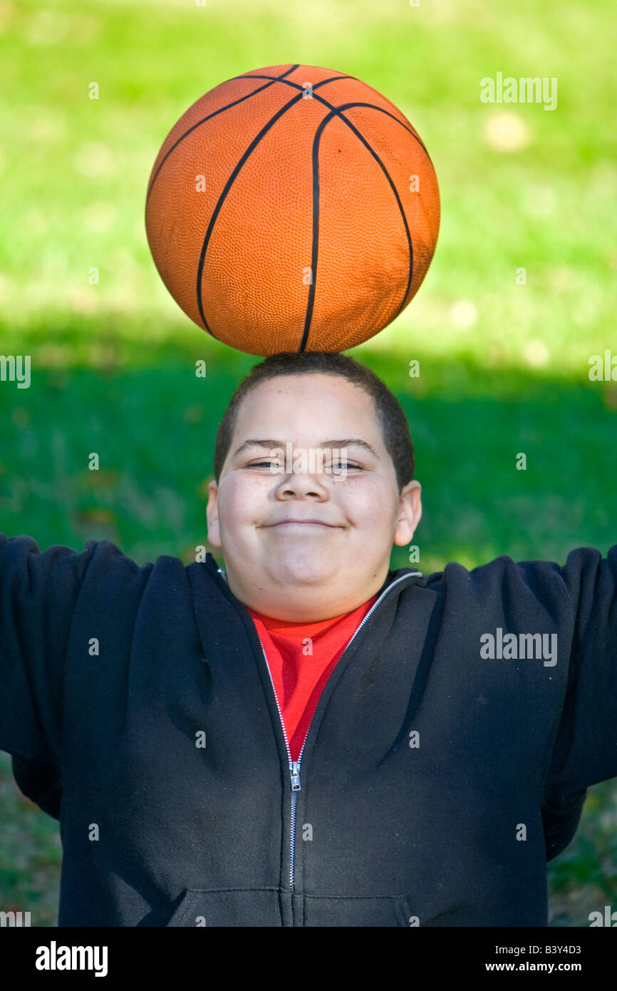 Boy with basketball balanced on head Stock Photo Alamy