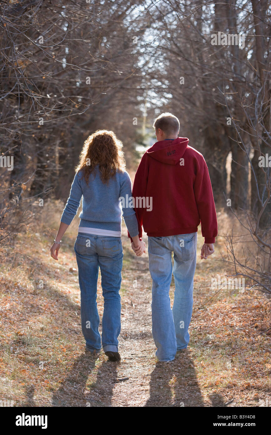 Couple walking while holding hands Stock Photo Alamy