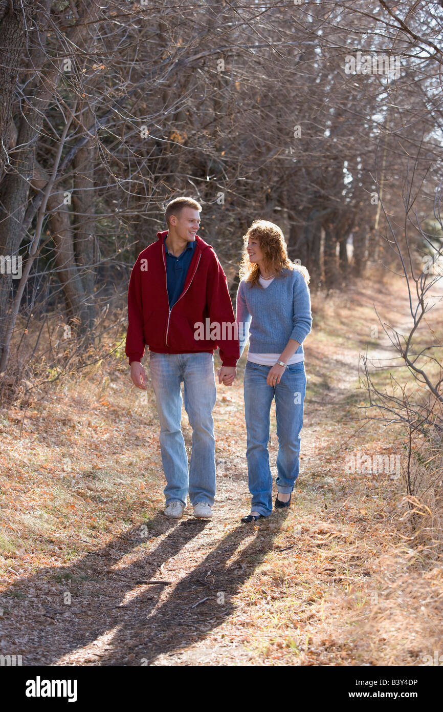 Couple walking while holding hands Stock Photo Alamy