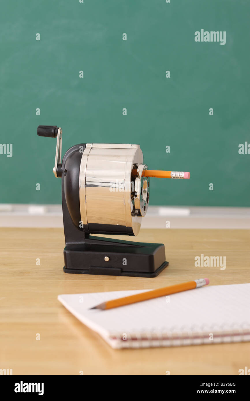 School education still life of a pencil sharpener and notepad Stock Photo