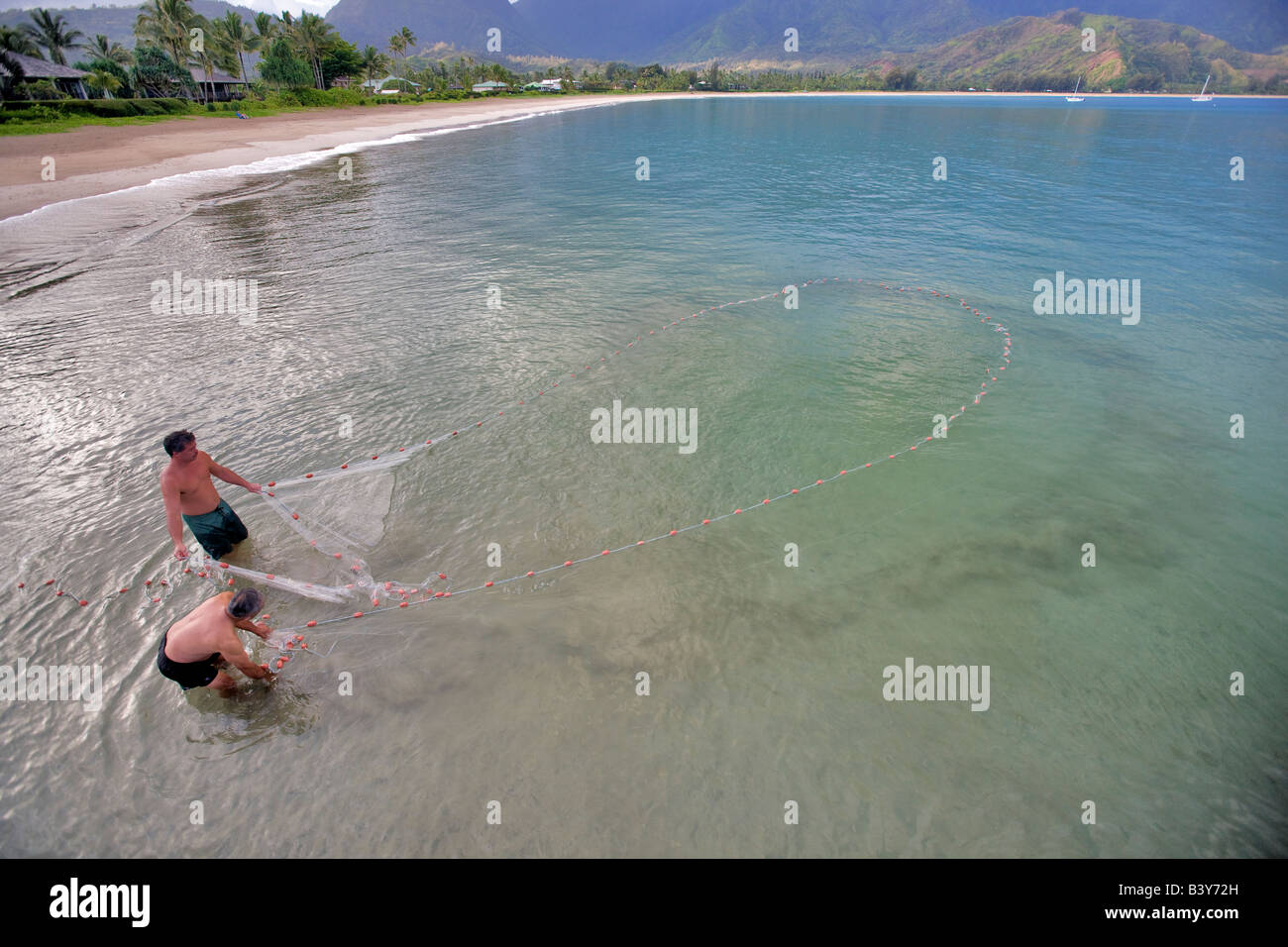Native hawaians net fishing for mackerel Hanalei Bay Kauai Hawaii Stock