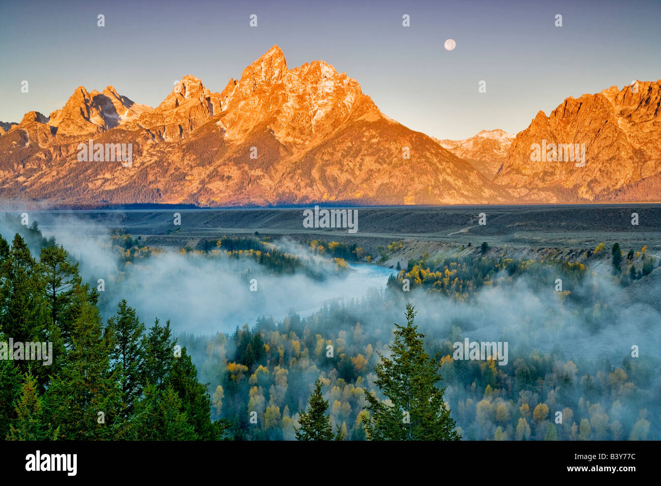 Full moonrise with fog fall color Snake River and Teton Mountains Grand