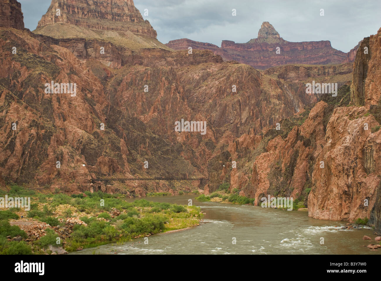 USA, Arizona, Grand Canyon NP.  The Colorado River winds its way past Phantom Ranch and a hiker's suspension bridge. Stock Photo