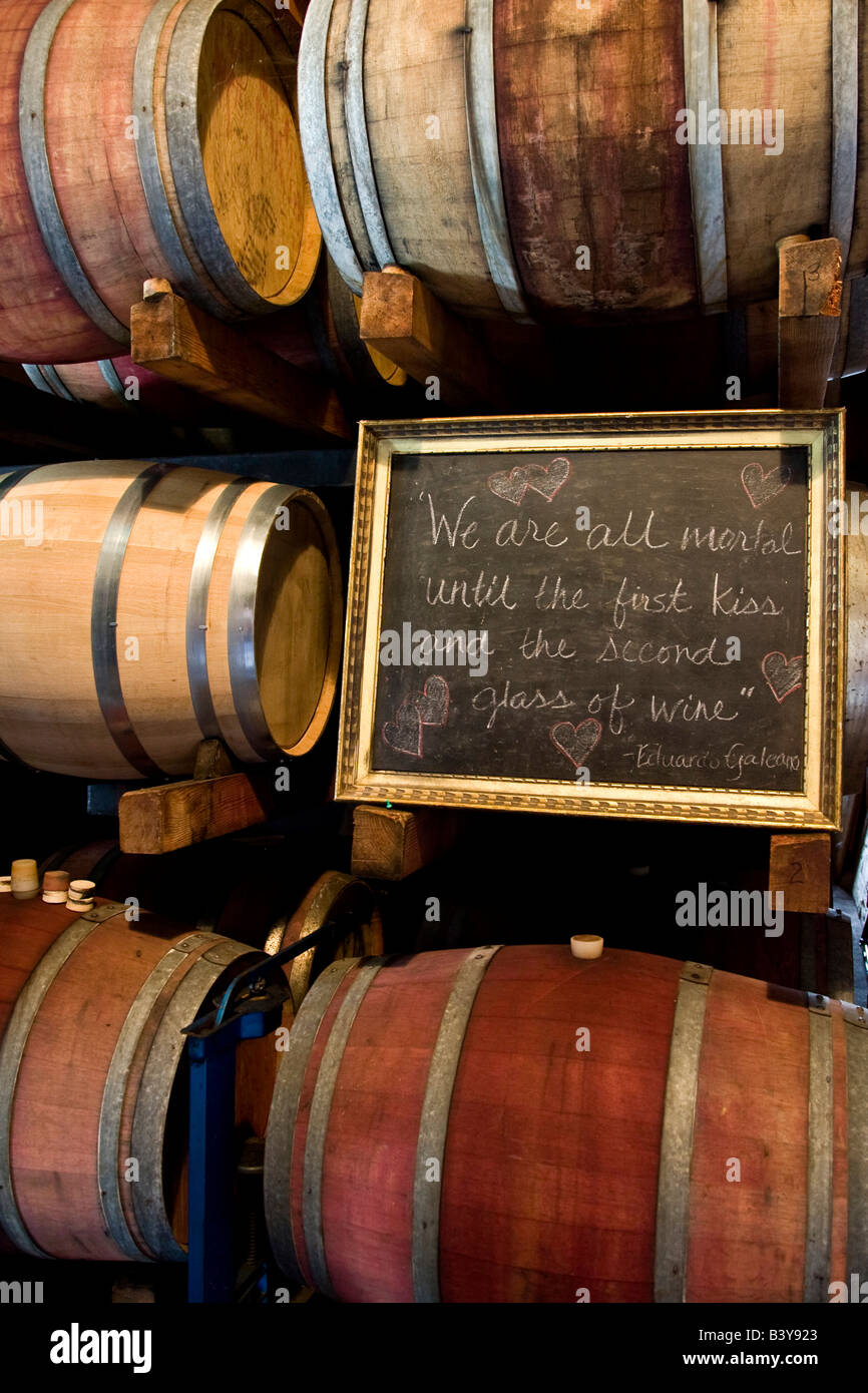 USA, California, Napa Valley. An Eduardo Galeano quote on a chalkboard among wooden barrels of wine. Stock Photo