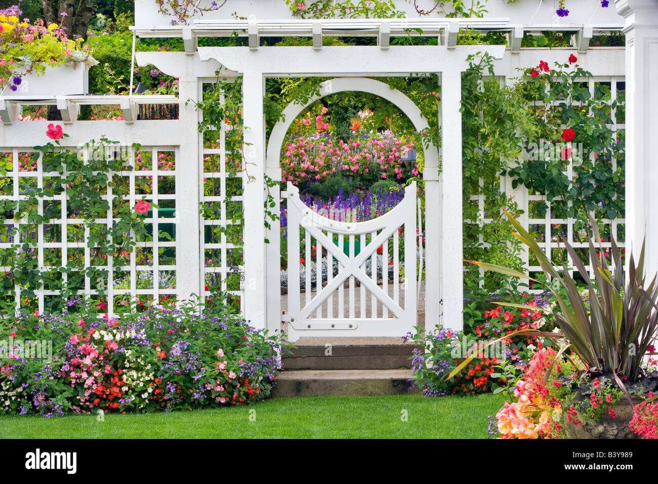 Gate with flowers at Butchart Gardens B C Canada Stock Photo