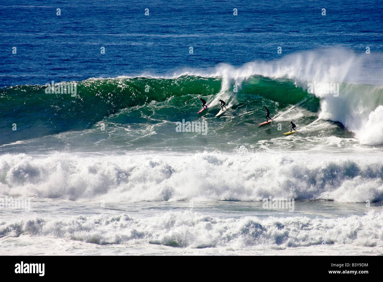 Four Surfers Catch A Wave At The 2006 Mavericks Big Wave