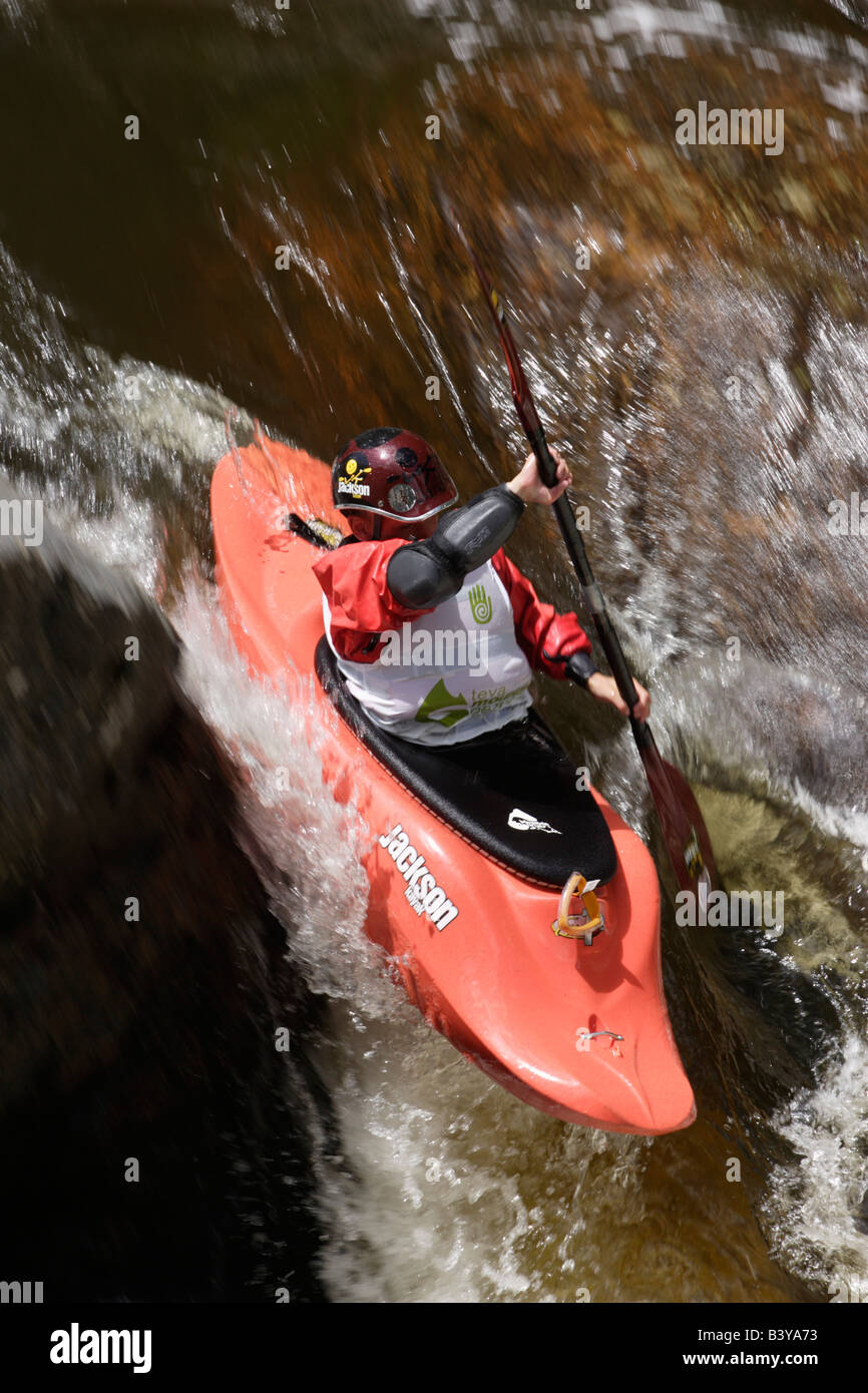 Colorado. A kayaker, 11, paddles over an eight-foot waterfall while competing in the '05 TEVA Mountain Games Extreme Creek Race Stock Photo