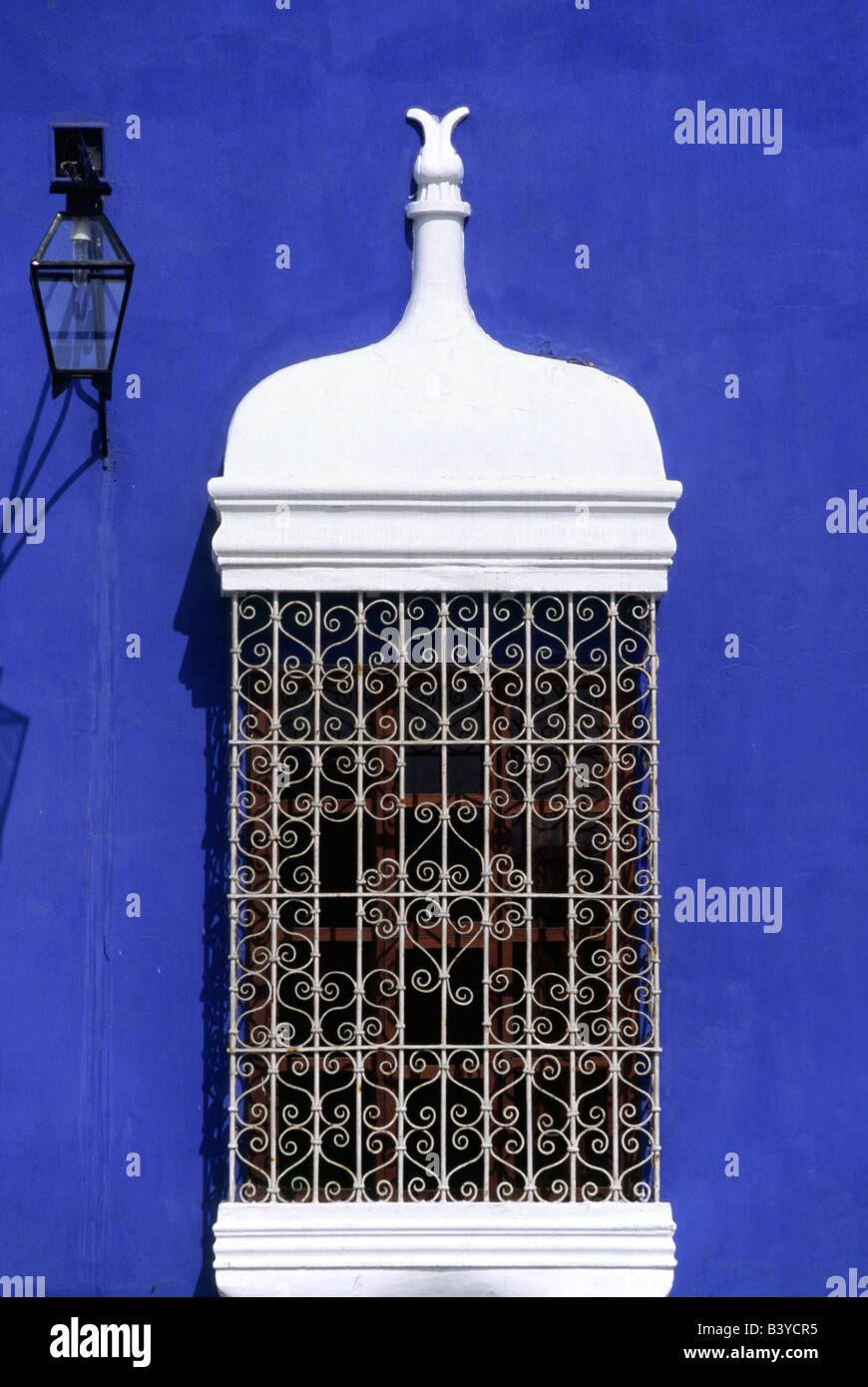 Ornate grillwork decorating window boxes and pastel shades are typical