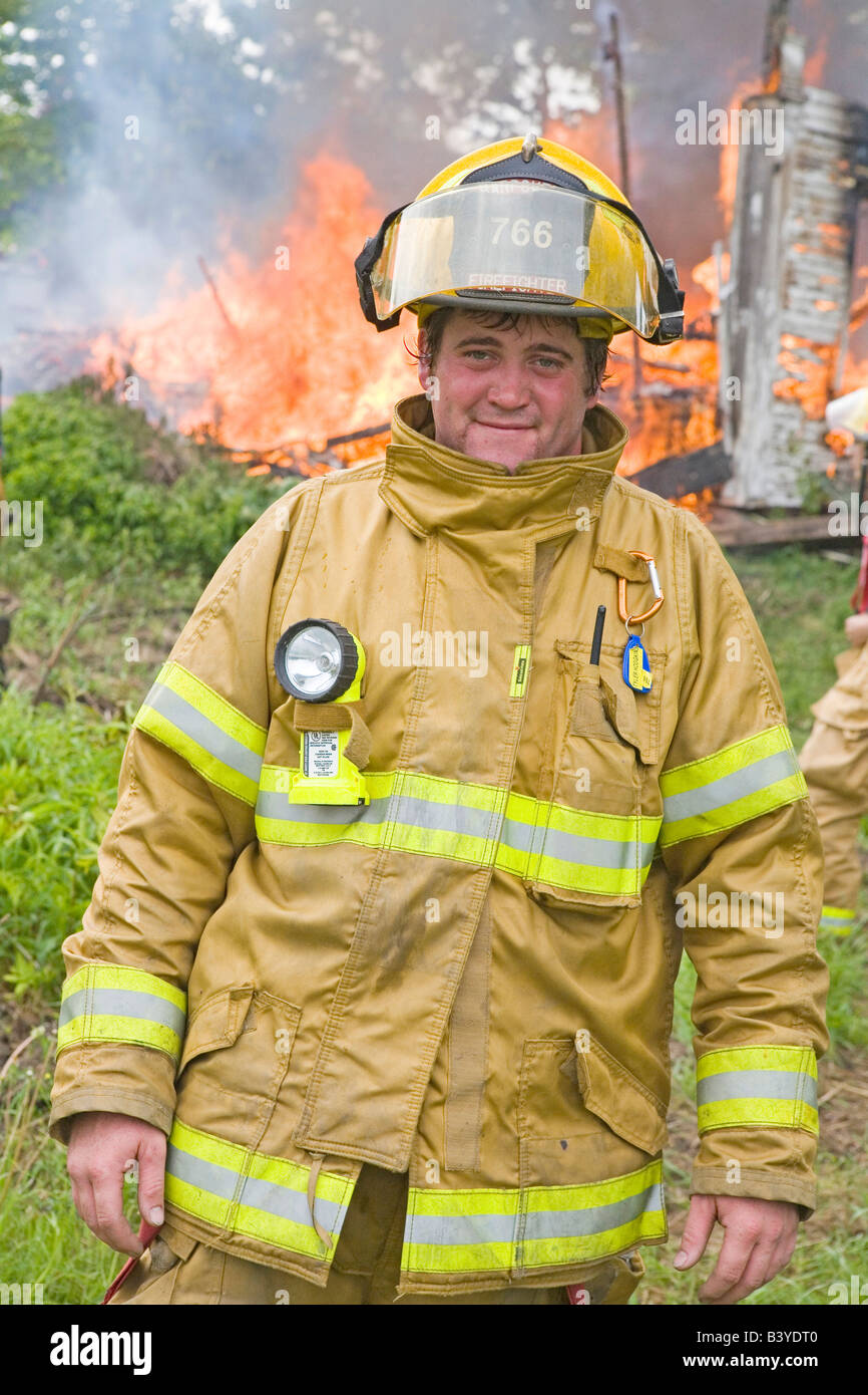 USA, Maine, Harpswell. Fireman standing in front of a house fire Stock