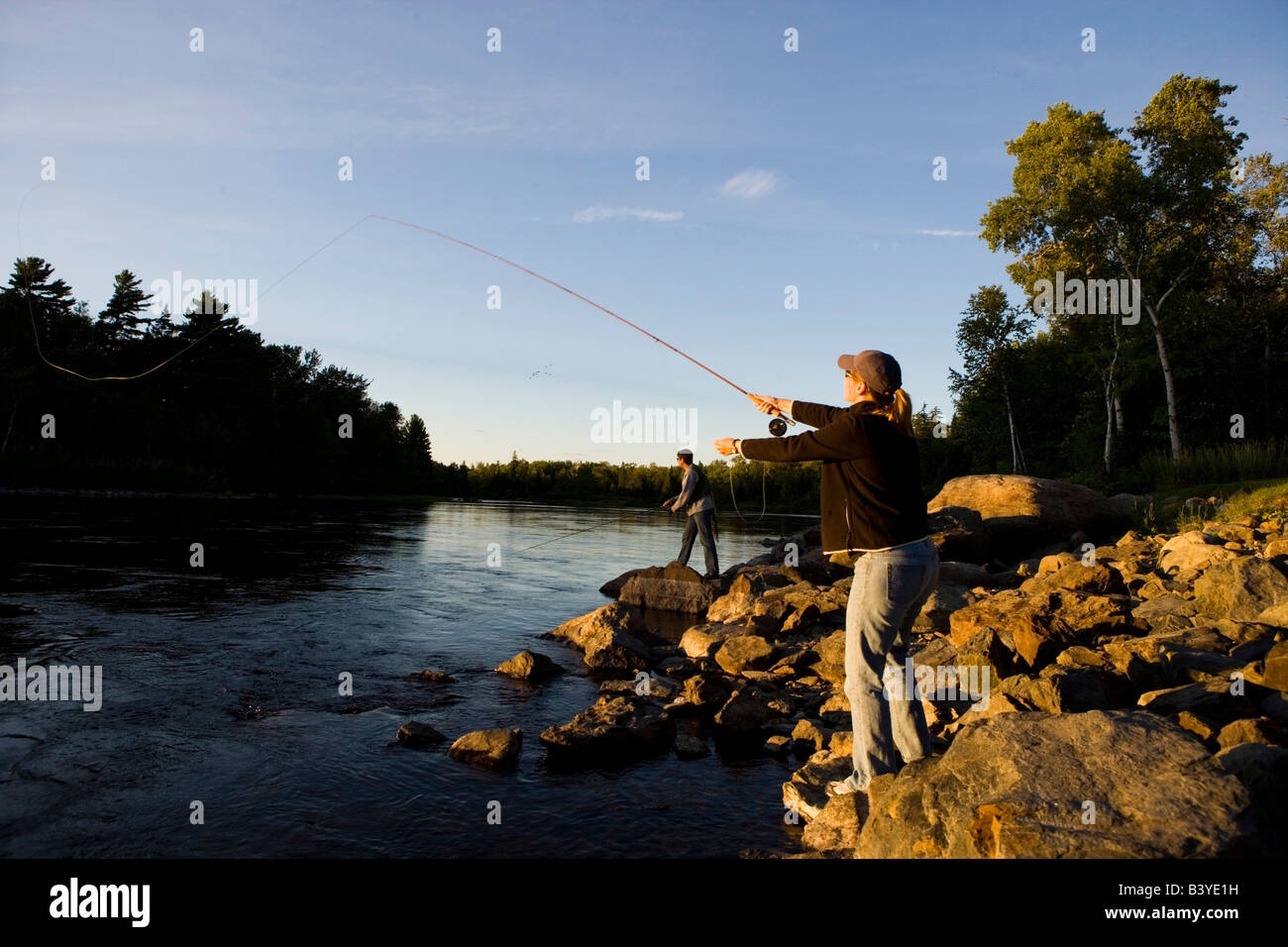 A couple fly-fishing on the Moose River below the dam on Brassua Lake Stock Photo - Alamy