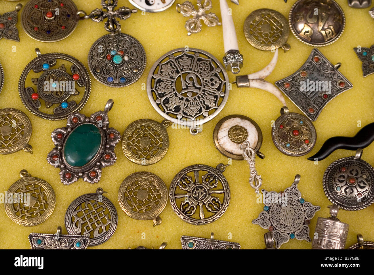 Silver jewellery is dispayed in Dharamsala. The Tibetan style pendants are popular with tourists. Stock Photo