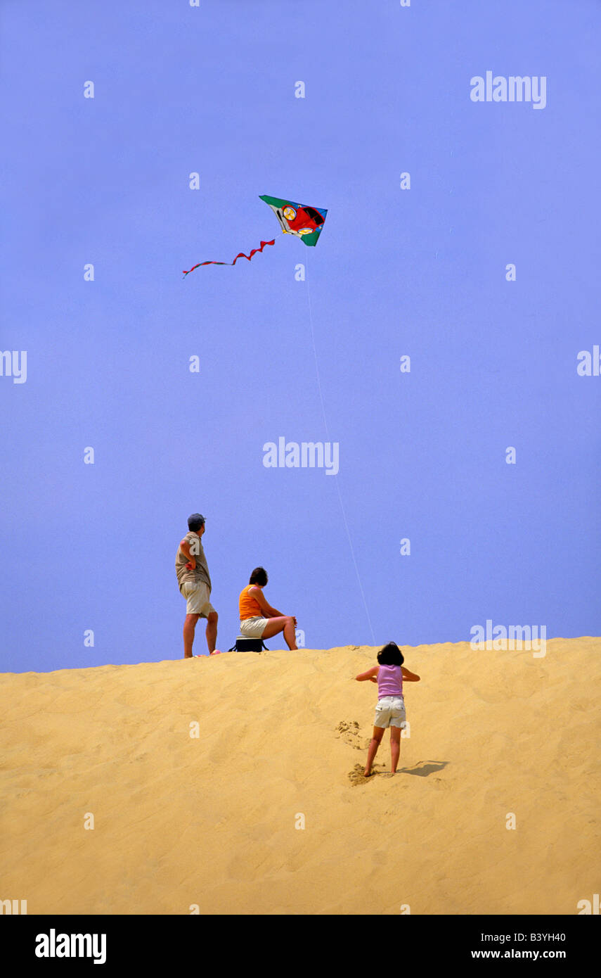 Family flying a kite at Jockey's Ridge State Park, Outer Banks, North
