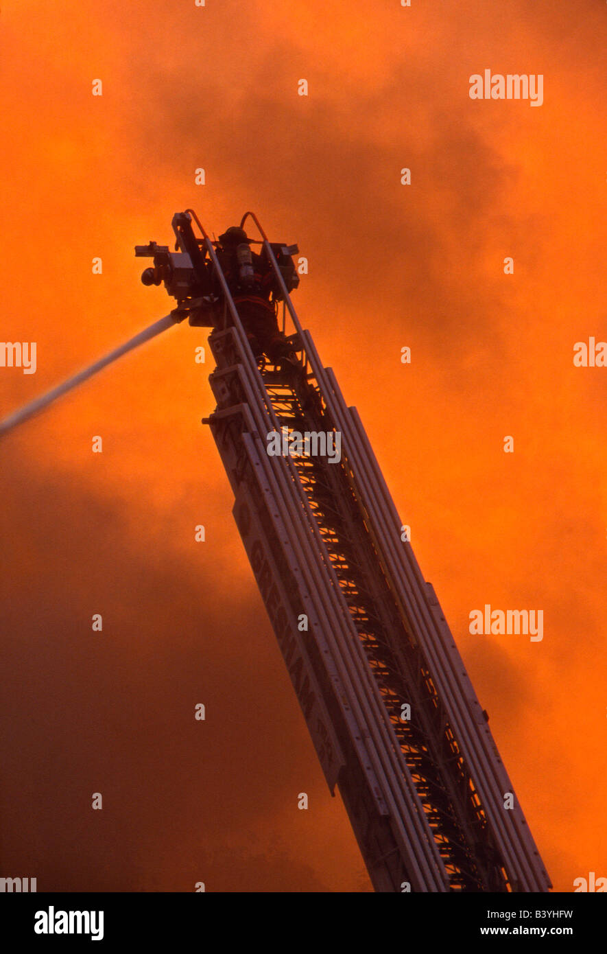 USA, Oregon, Troutdale. Fireman on ladder truck with fire hose