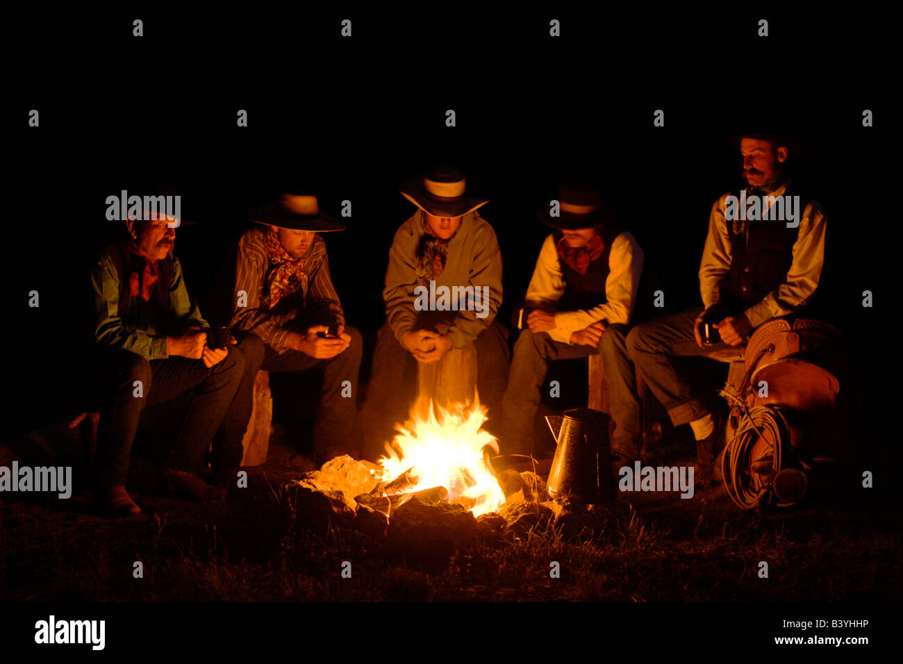 Cowboys sitting around campfire night hi res stock photography and