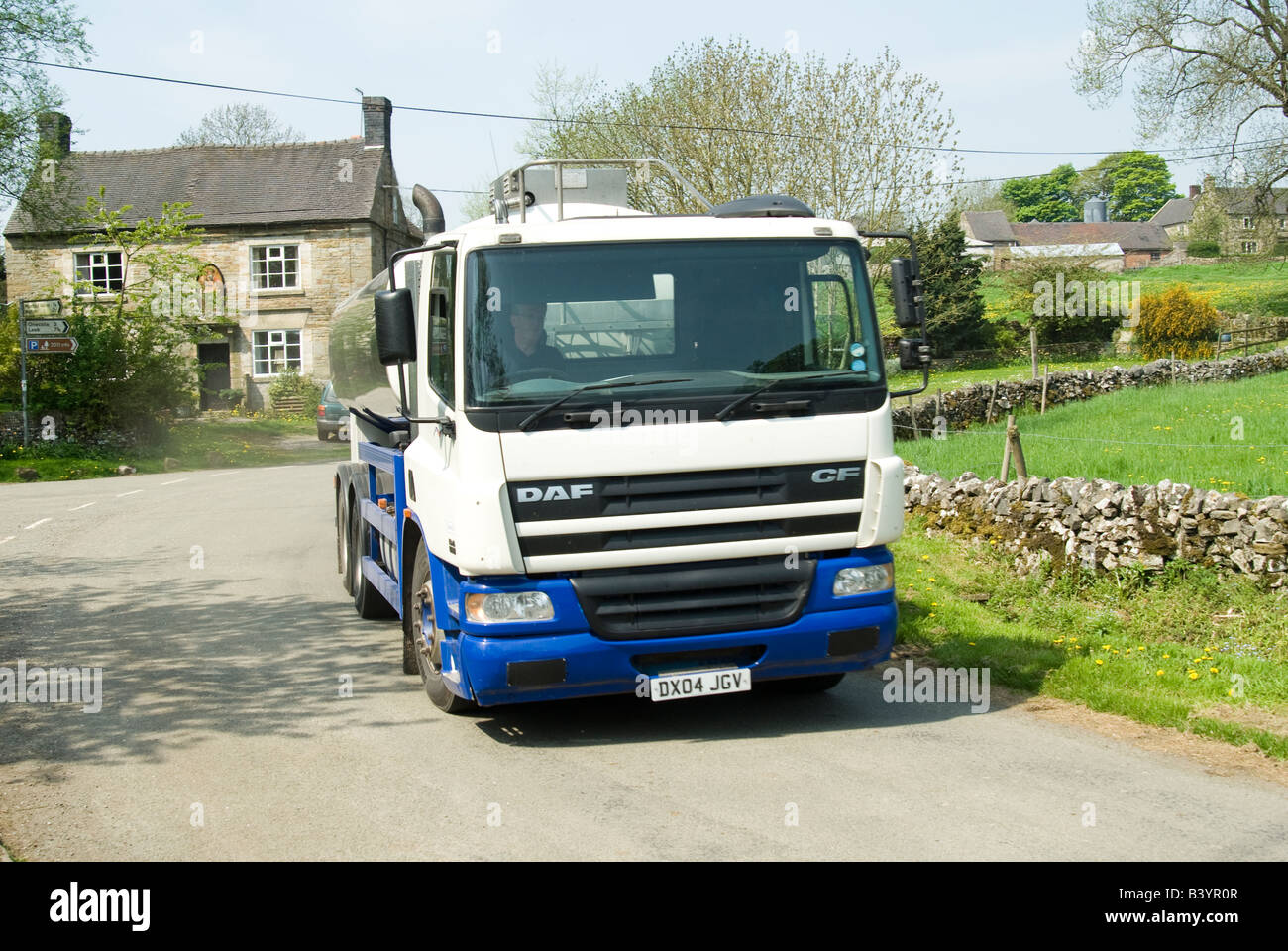 daf milk tanker travelling through a small village in the derbyshire countryside uk Stock Photo