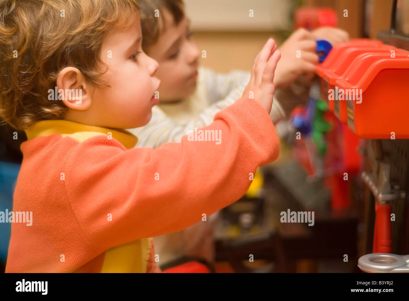 two boys playing with toy tools Stock Photo