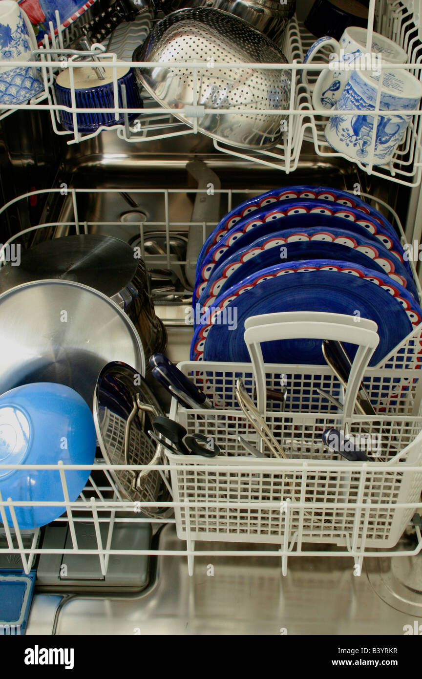 A dishwasher filled with plates, pots and pans Stock Photo Alamy