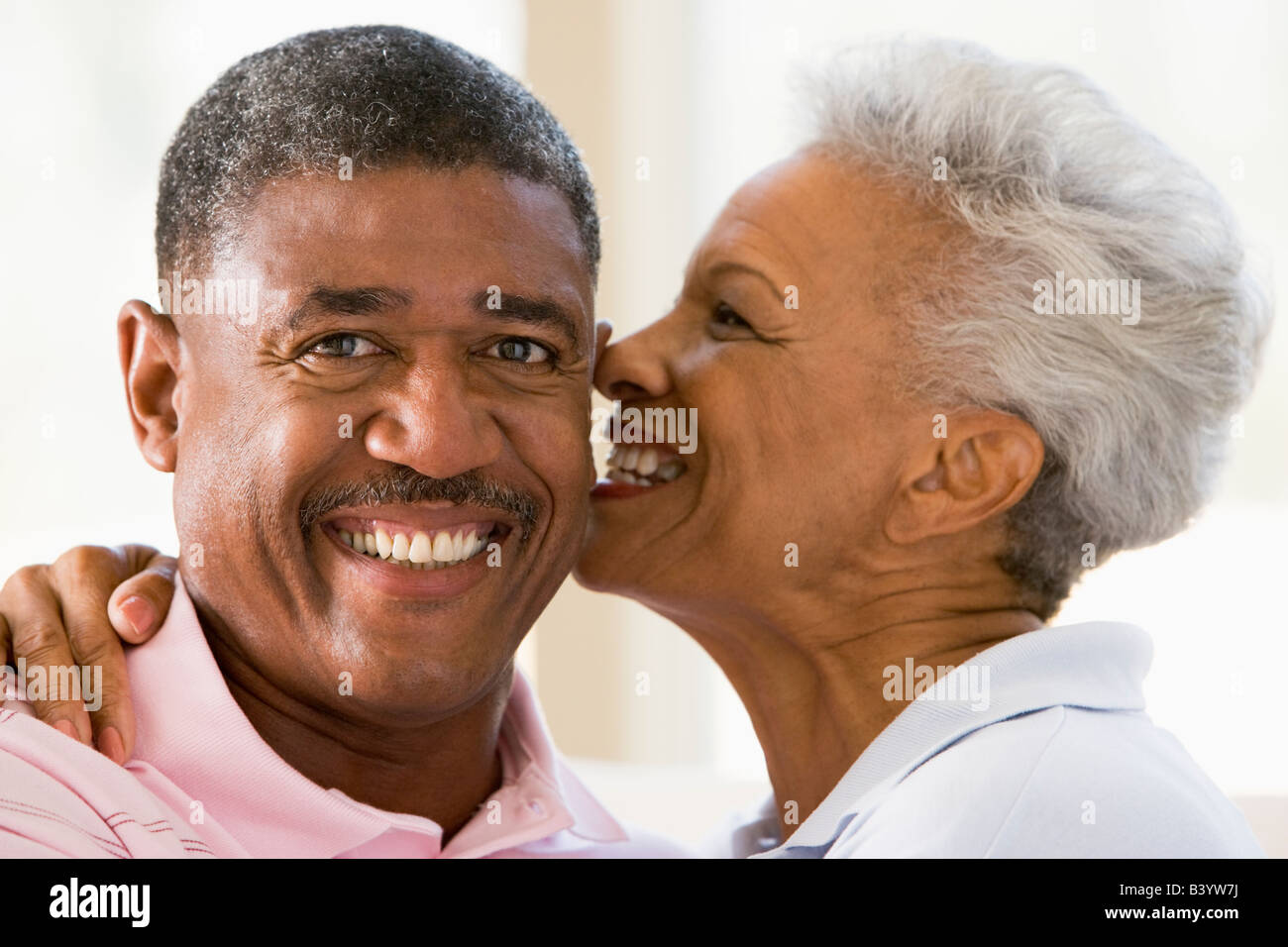 Loving African American wife kissing her husband on the cheek Stock ...