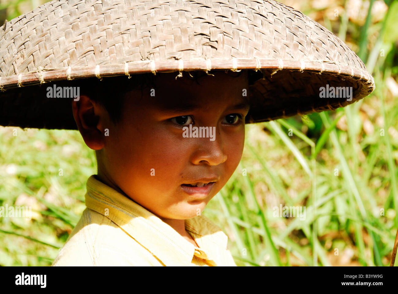 bali aga boy wearing traditional hat ,  bali aga village life , women carrying goods on her head , julah, bali aga village, bali Stock Photo