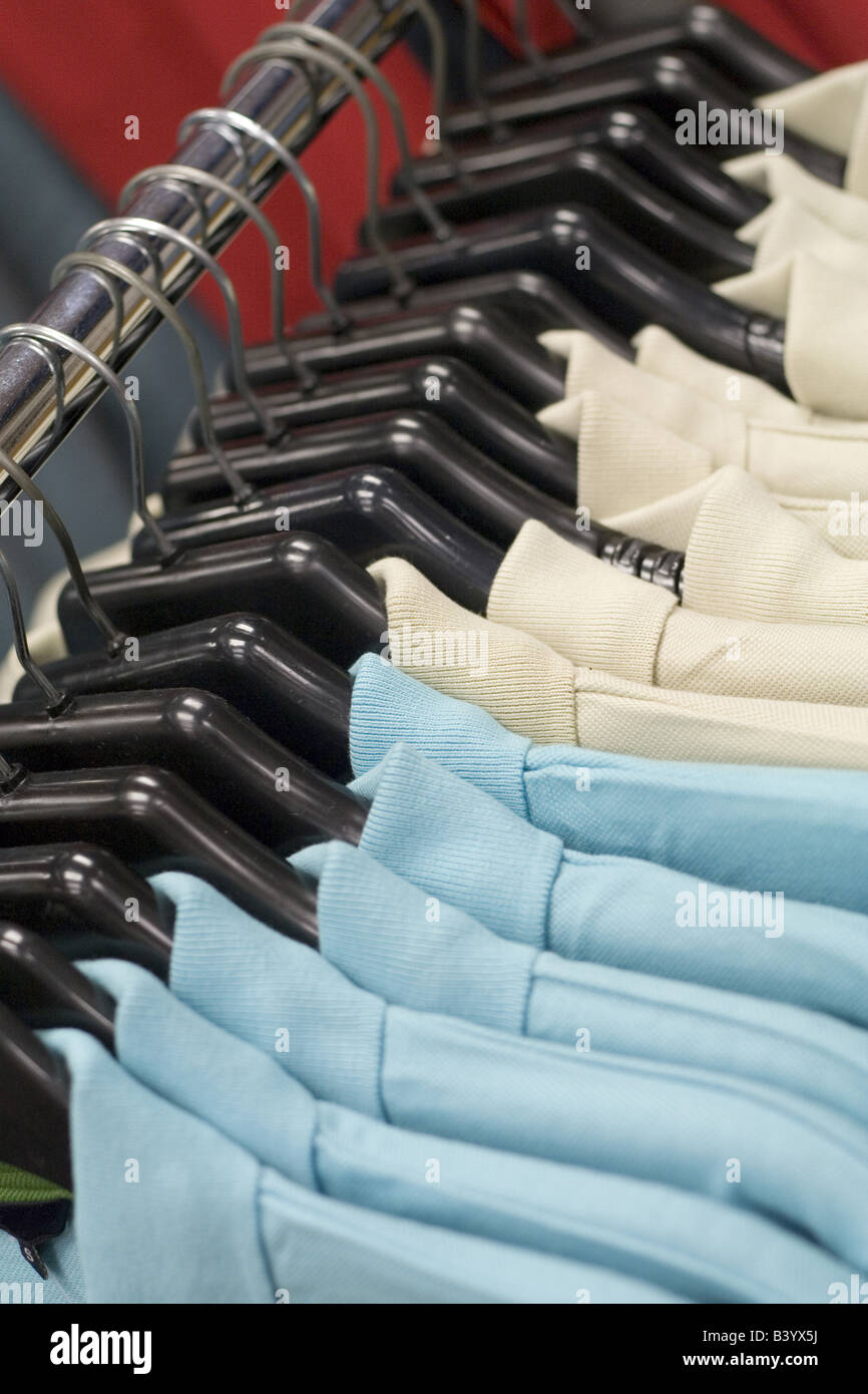 Blue and Cream shirts hung on a rail in a shop Stock Photo - Alamy