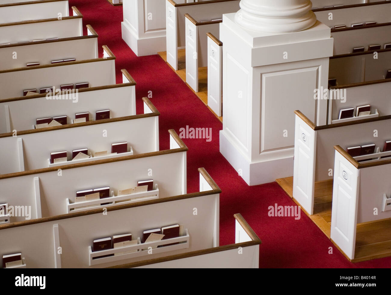 White church pews and red carpet aisle Stock Photo Alamy