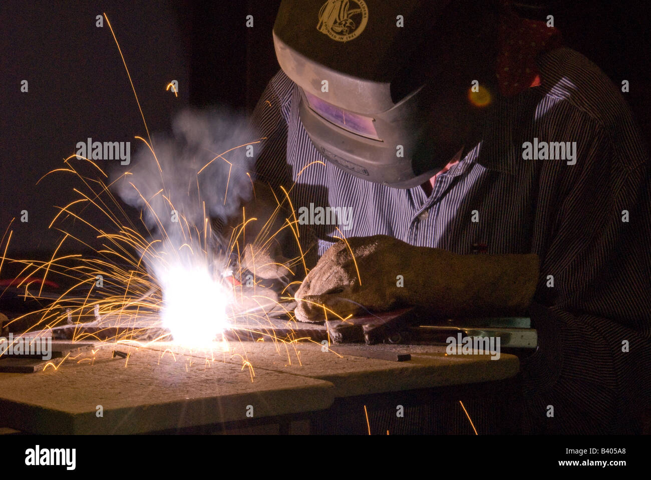 Person welding in a workshop Stock Photo - Alamy