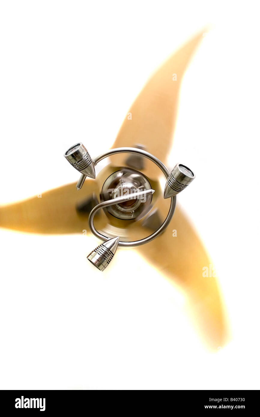 A Modern Ceiling Fan With Only Three Blades While In Motion