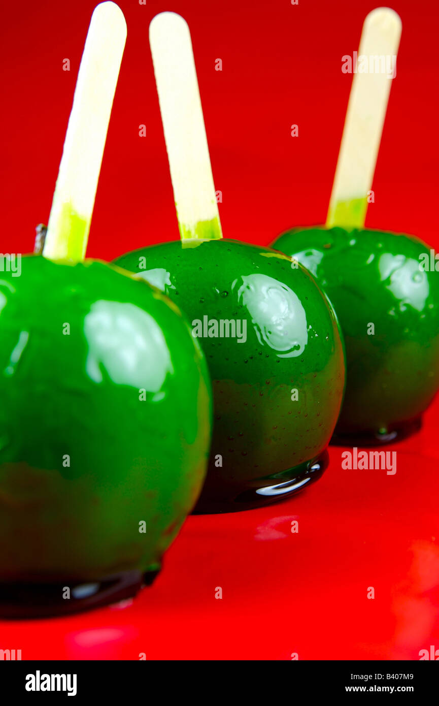 Toffee apples isolated against a red background Stock Photo Alamy