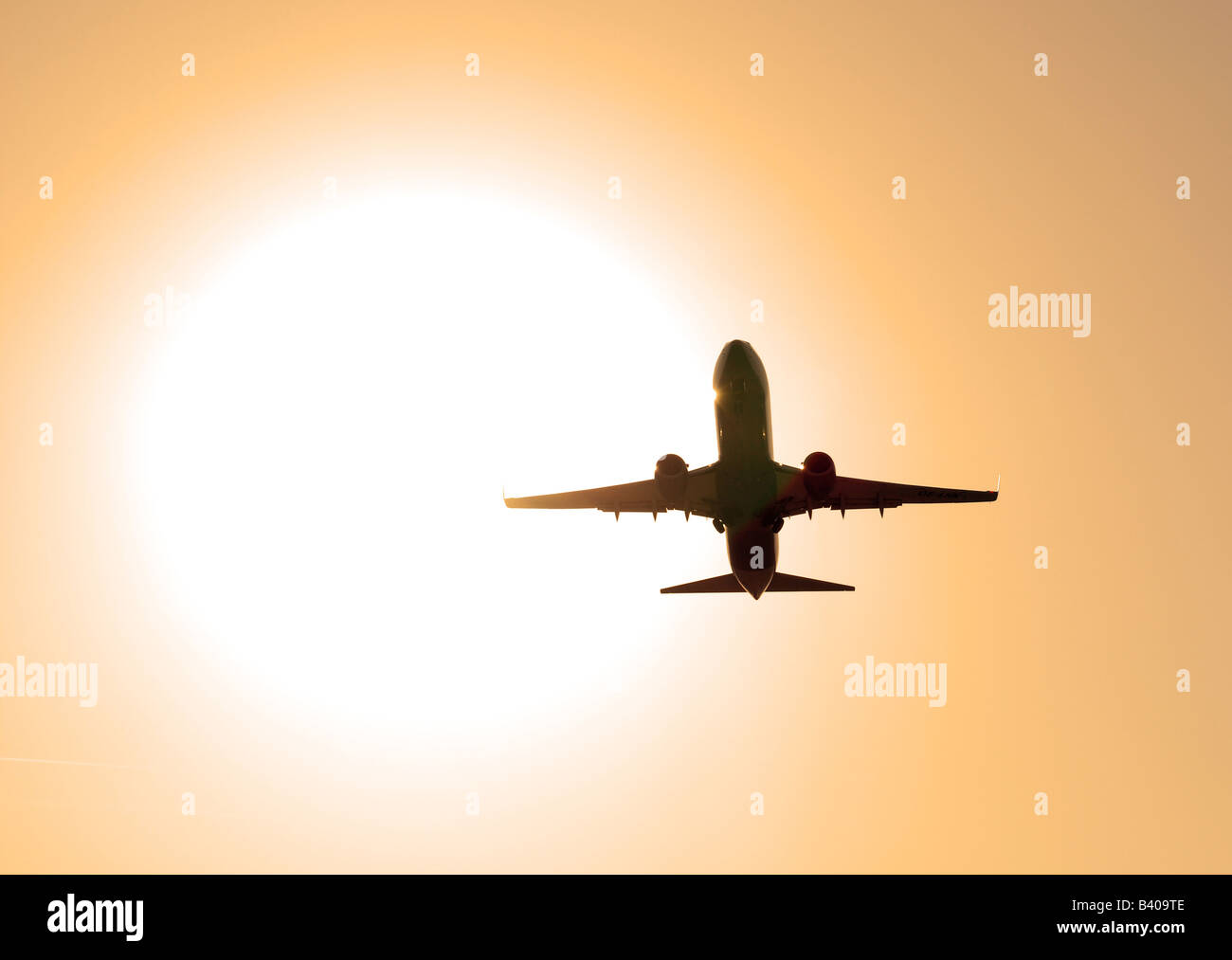 Airplane take off at sunset Stock Photo