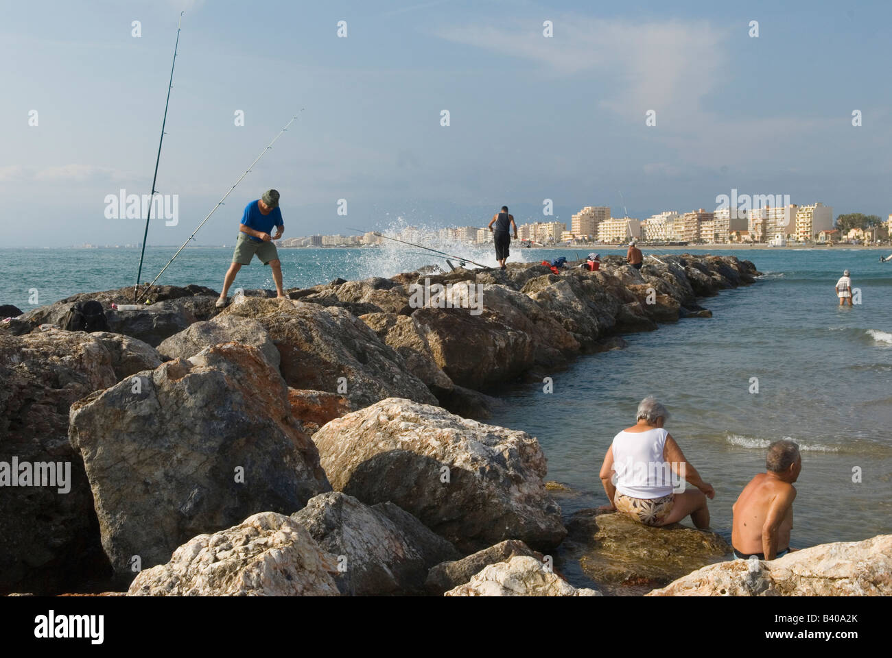 Canet Plage nr Perpignan South of France Beach scene Man made breakwater men fishing Stock Photo