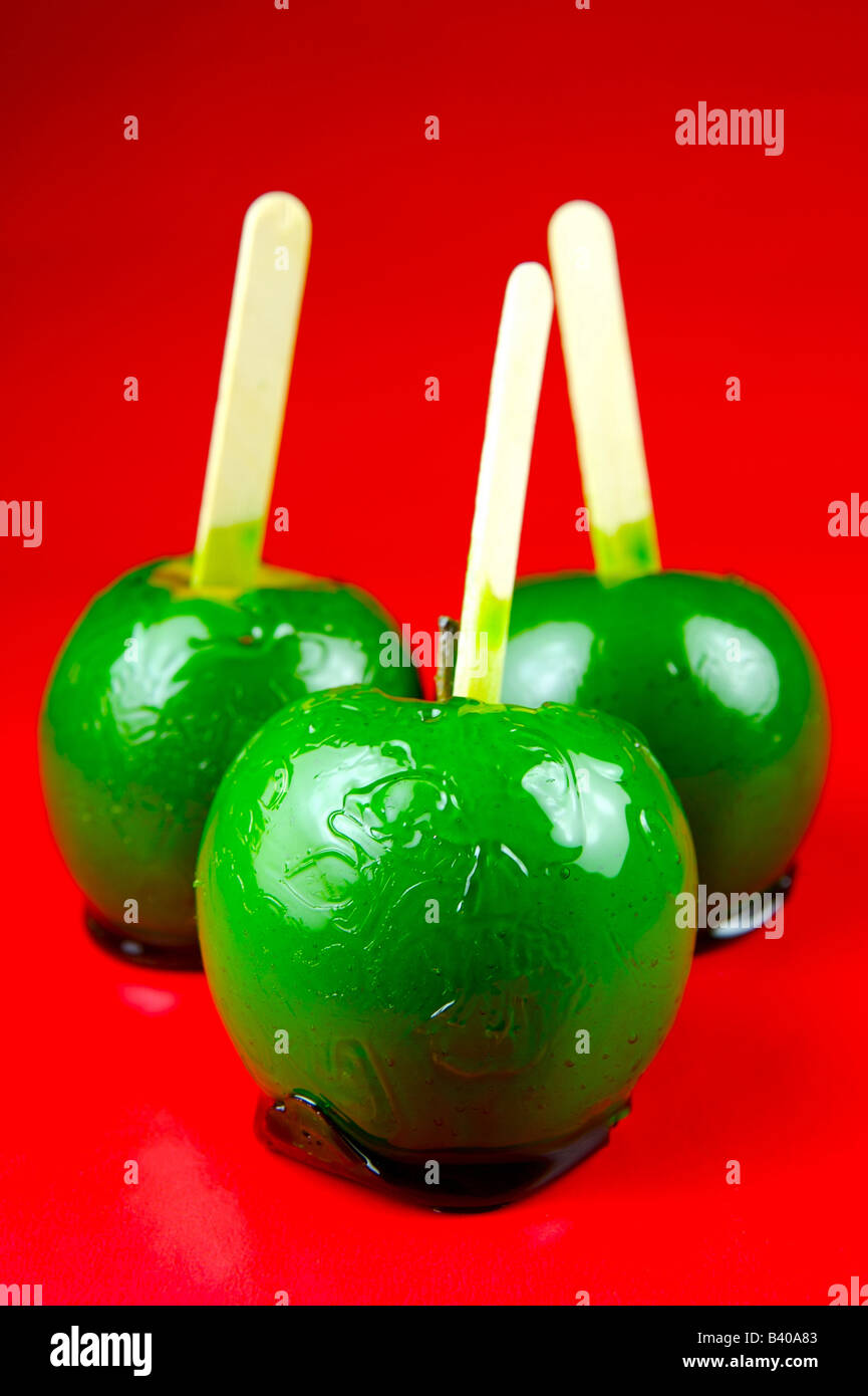 Toffee apples isolated against a red background Stock Photo Alamy