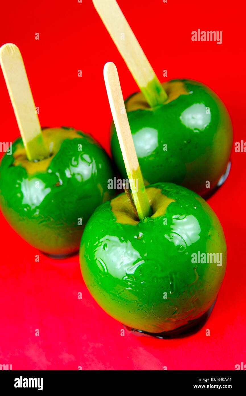 Toffee apples isolated against a red background Stock Photo Alamy