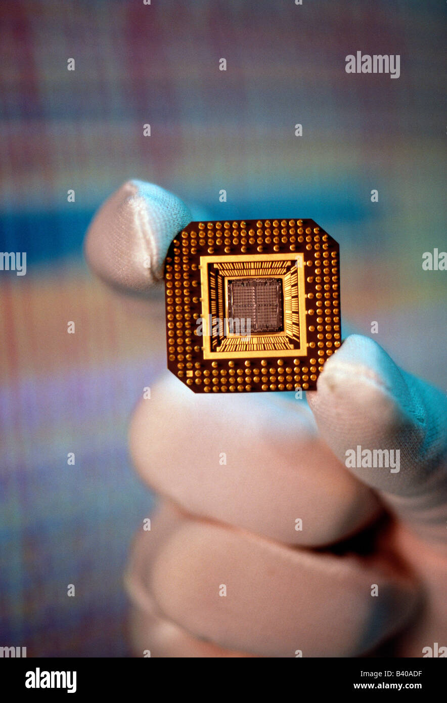 Technician In Clean Room Environment Holds Micro Computer