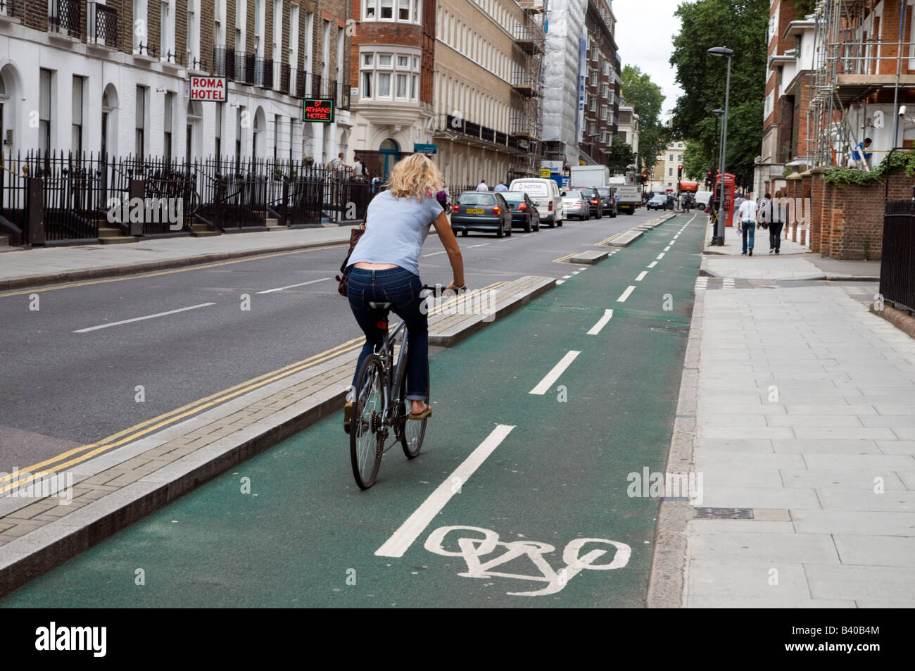 Cyclist riding in bicycle lane London England UK Stock Photo