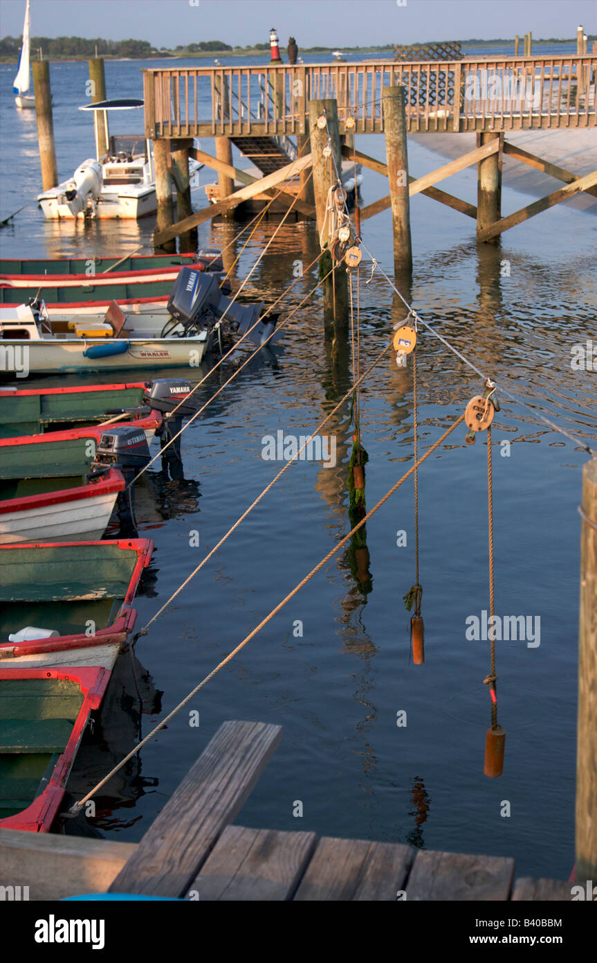 Fishing Skiffs tied up to a dock Stock Photo