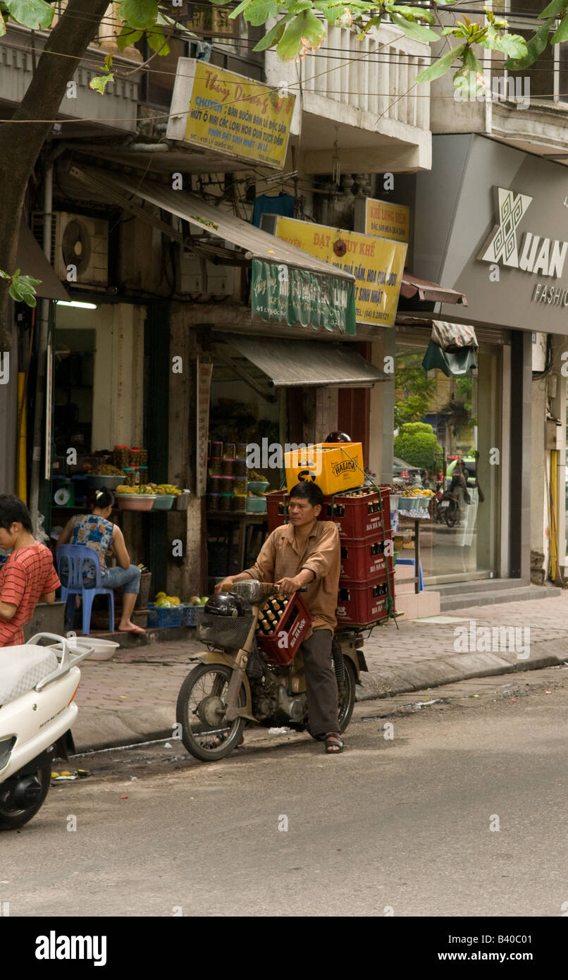 Man transporting several beer crates on his motorbike, Hanoi, Vietnam Stock Photo