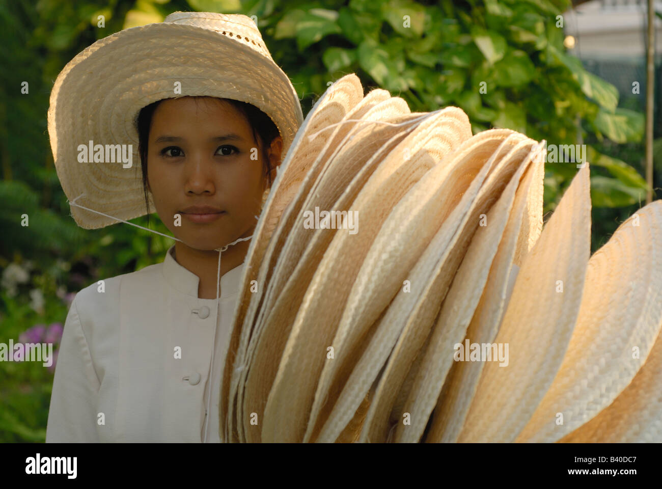 Female staff member with sun hats. Oriental Hotel Bangkok Stock Photo