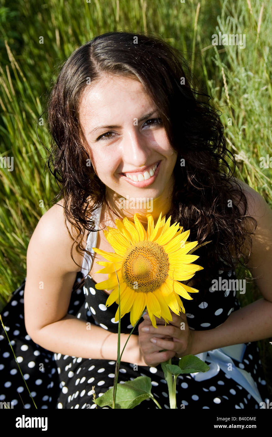 portrait of smiling girl with sunflower Stock Photo - Alamy