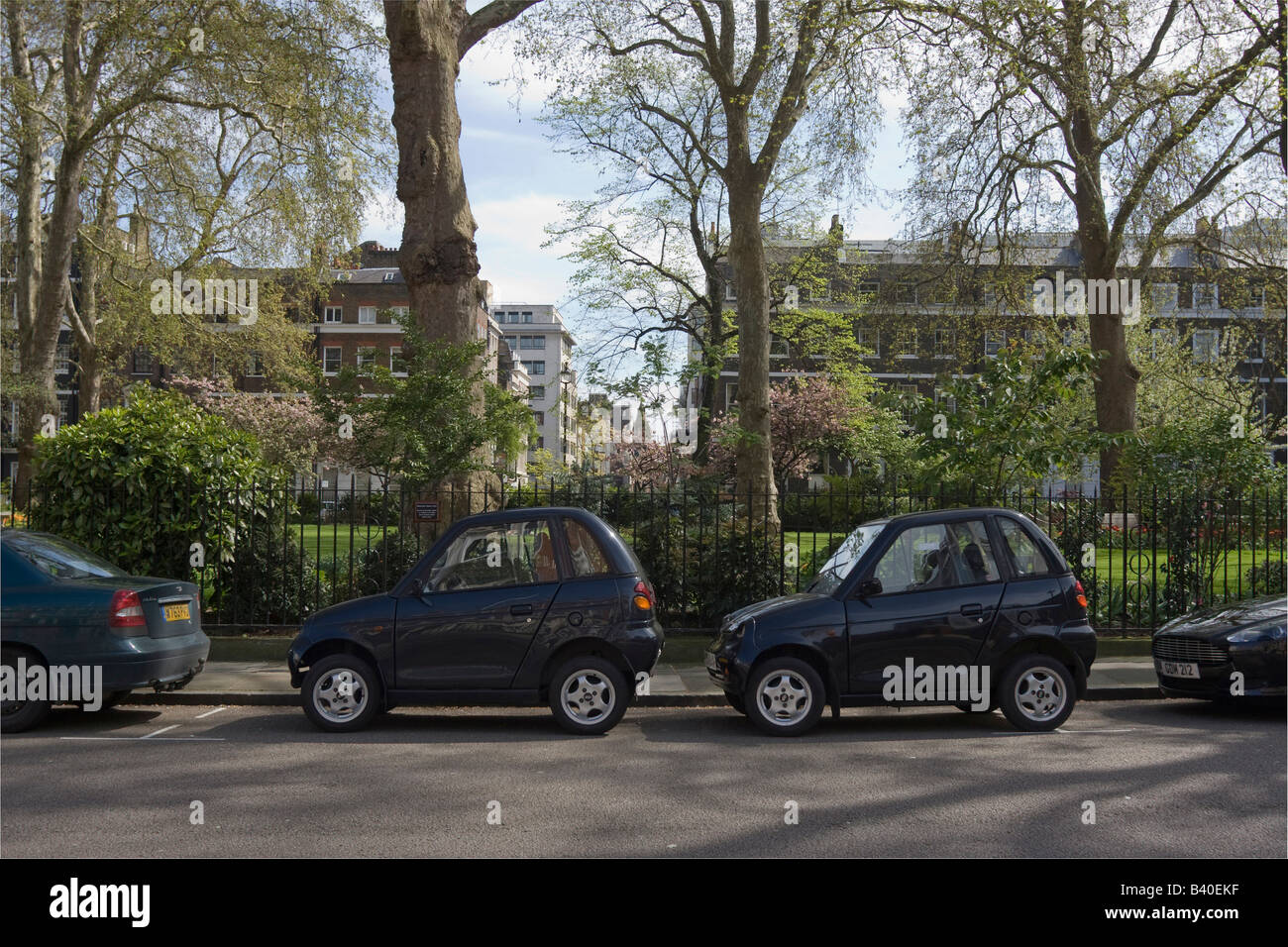 2 Reva G-Wiz electric cars parked on one parking space Manchester Square London GB UK Stock Photo