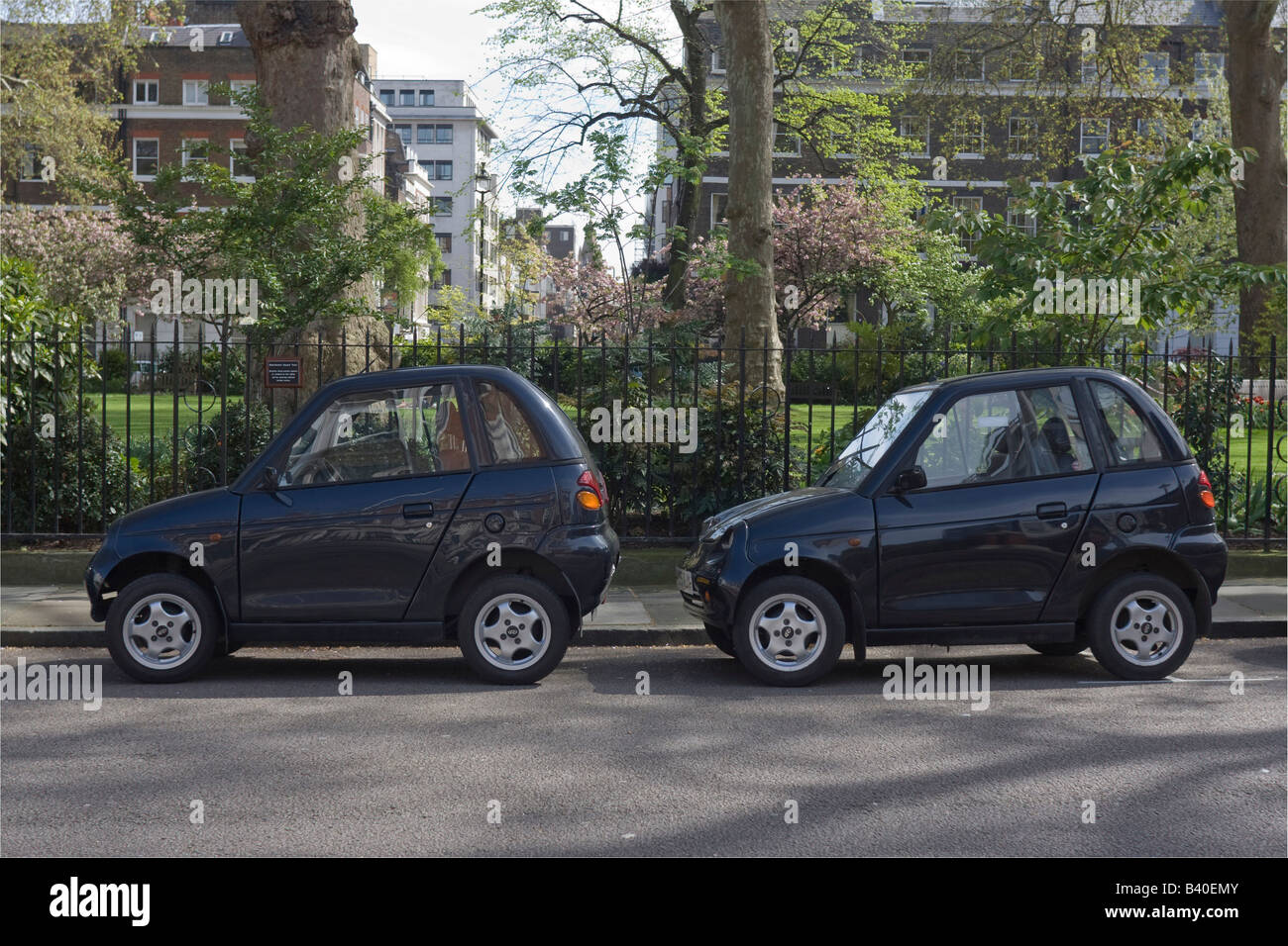 2 Reva G-Wiz electric cars parked on one parking space Manchester Square London GB UK Stock Photo