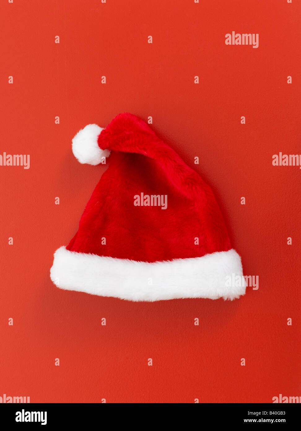 Christmas Santa Claus hat on red background Stock Photo