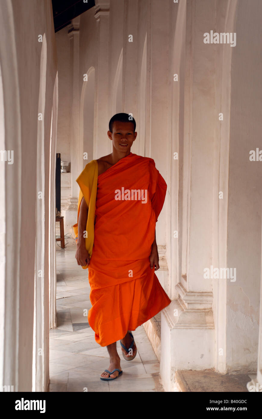 Buddhist Monk, orange Saffron robes walking in Temple Thailand Stock Photo
