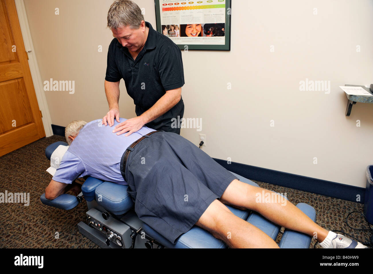 Adult receiving chiropractor chiropratic treatment Stock Photo