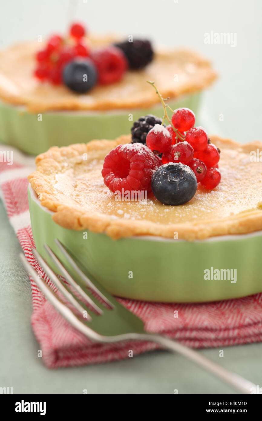 Lemon tarts topped with fresh berries Stock Photo