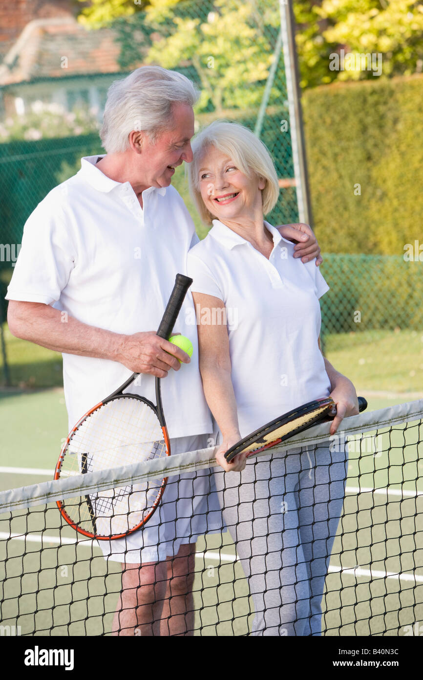 Couple playing tennis and smiling Stock Photo