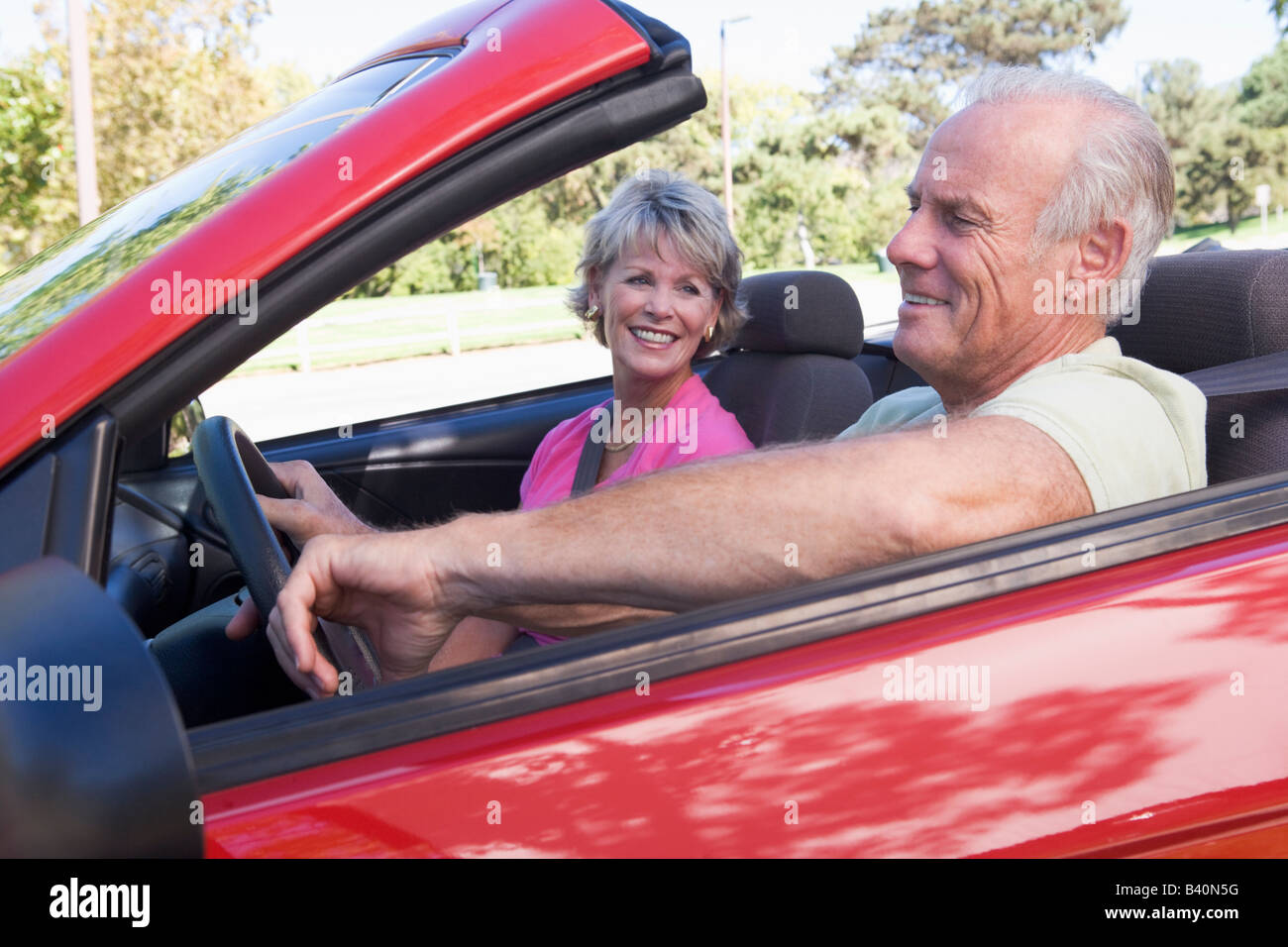 Couple in convertible car smiling Stock Photo