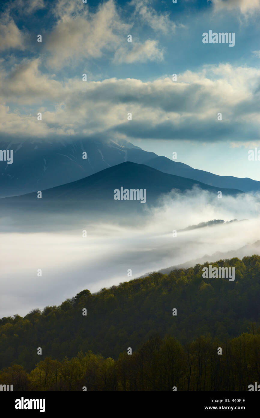 mist lying on the Piano Grande at dawn, Monti Sibillini National Park, Umbria, Italy Stock Photo